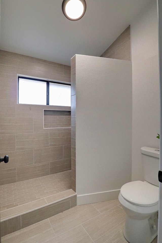 full bath with a walk in shower, toilet, and baseboards