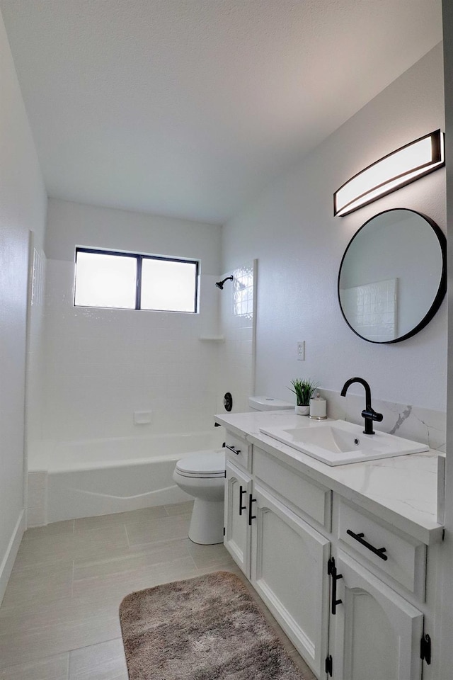 bathroom featuring tile patterned floors, toilet, a sink, double vanity, and shower / bath combination