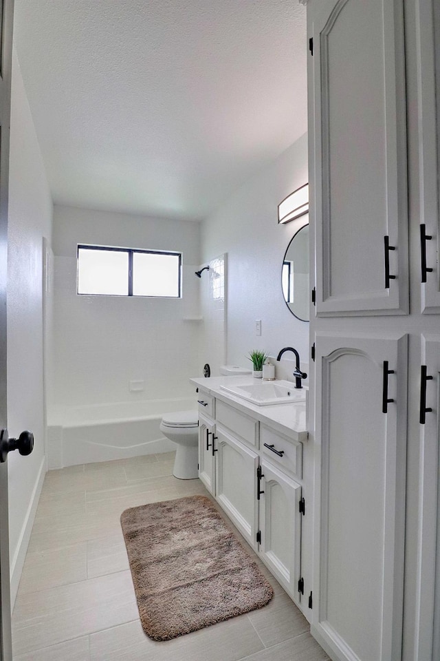 full bath featuring toilet, double vanity, a sink, tile patterned flooring, and tub / shower combination