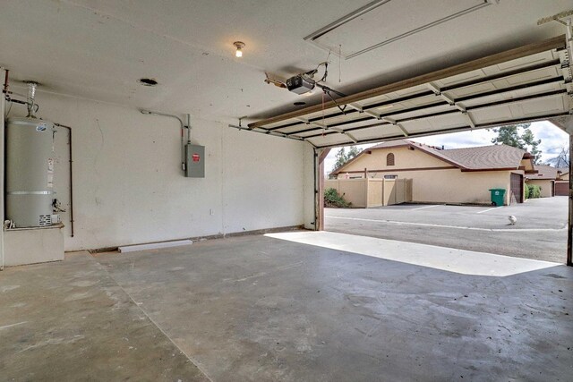 1010 S Clovis Ave Unit 101, Fresno, CA 93727 - garage featuring secured water heater, a garage door opener, and electric panel