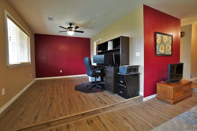 465 Mike Ct, Lemoore, CA 93245 - home office featuring wood finished floors, a ceiling fan, baseboards, and an accent wall