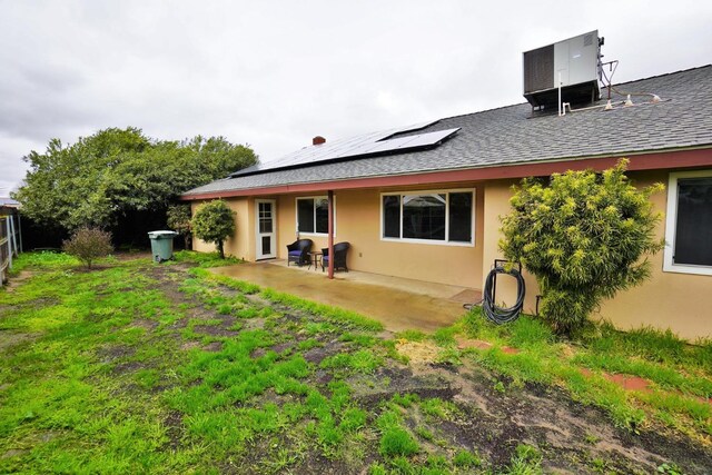 465 Mike Ct, Lemoore, CA 93245 - rear view of property with solar panels, a patio area, a shingled roof, and stucco siding