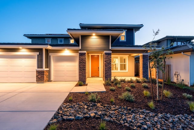 prairie-style house with an attached garage and driveway
