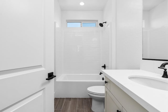 full bath with recessed lighting, shower / washtub combination, toilet, vanity, and wood finish floors