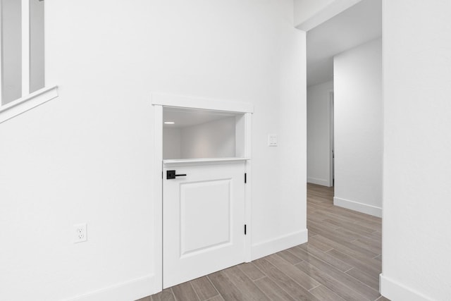 interior space with baseboards and wood finished floors