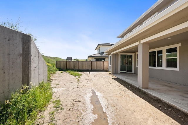 view of yard featuring fence and a patio