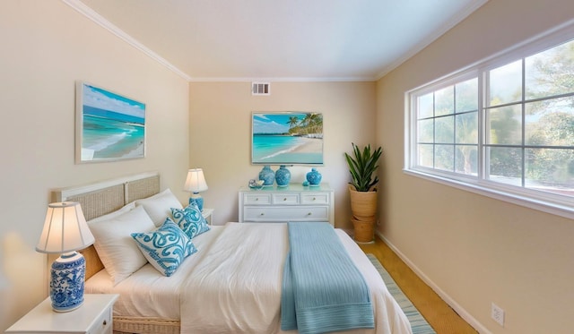 bedroom featuring baseboards, ornamental molding, and visible vents