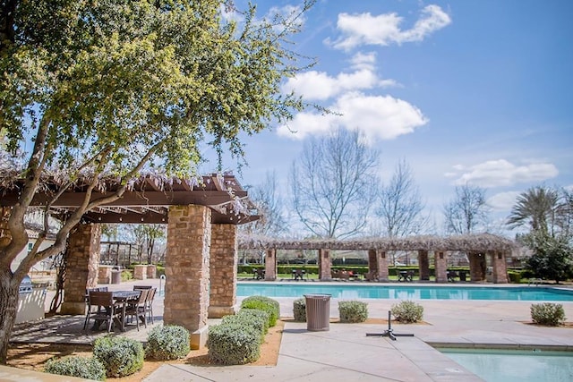 community pool with a patio area