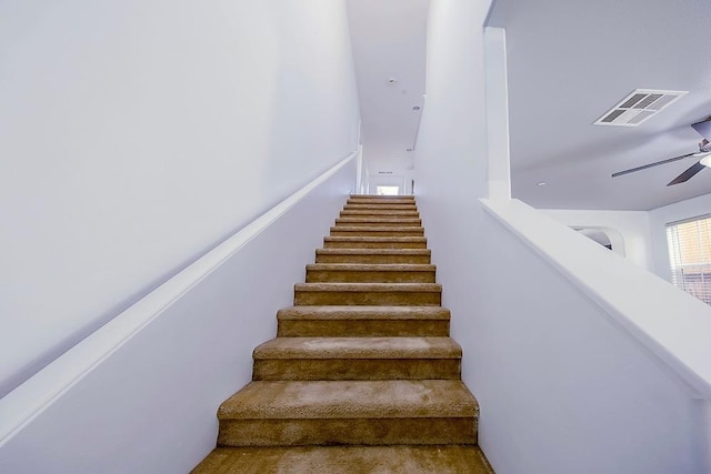 stairs featuring a ceiling fan and visible vents