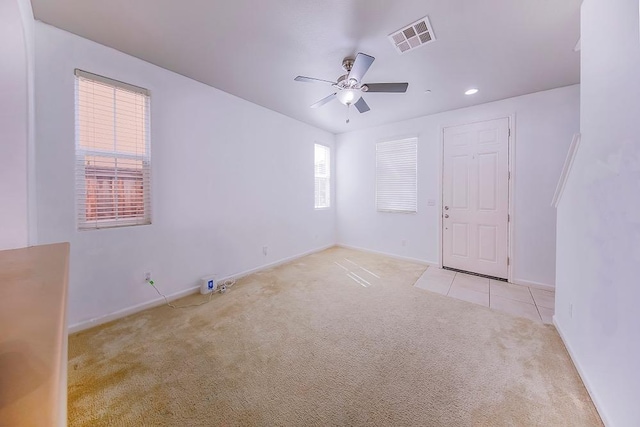 carpeted empty room featuring recessed lighting, visible vents, baseboards, and ceiling fan