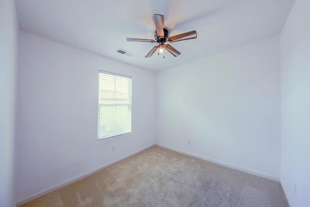 unfurnished room featuring visible vents, carpet floors, baseboards, and a ceiling fan