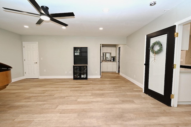 interior space featuring a ceiling fan, light wood-style floors, recessed lighting, and baseboards