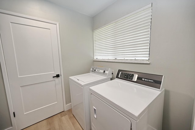 laundry room featuring light wood-style flooring, laundry area, and washer and dryer