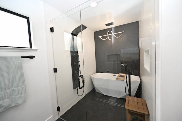 full bathroom featuring a shower stall, tile walls, tile patterned floors, and a freestanding tub