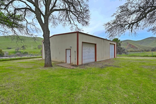 view of outbuilding featuring an outdoor structure and a mountain view