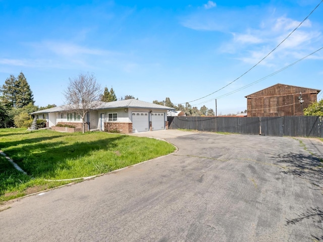 9414 E Belmont Ave, Sanger, CA 93657 - ranch-style house featuring asphalt driveway, a garage, and brick siding