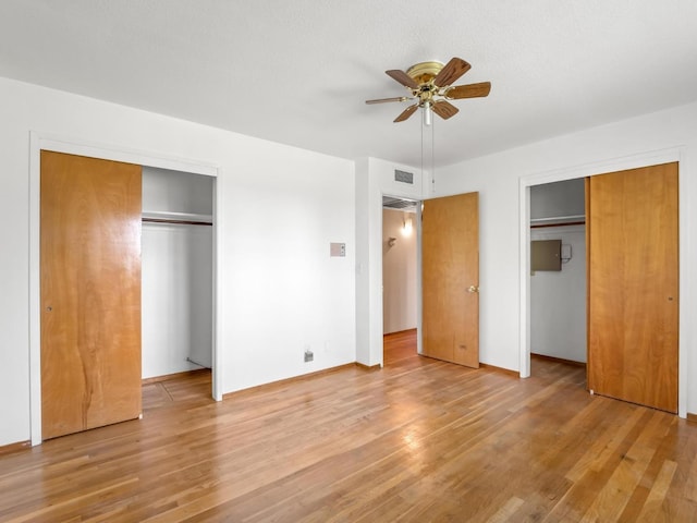 9414 E Belmont Ave, Sanger, CA 93657 - unfurnished bedroom with multiple closets, light wood-type flooring, and a ceiling fan