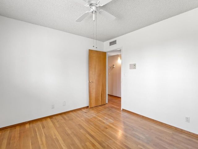 9414 E Belmont Ave, Sanger, CA 93657 - empty room featuring light wood-type flooring, a textured ceiling, and a ceiling fan