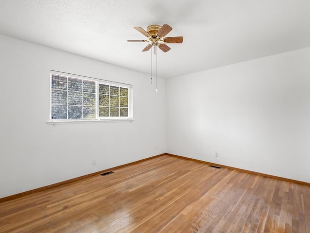 9414 E Belmont Ave, Sanger, CA 93657 - spare room with light wood-style floors and a ceiling fan