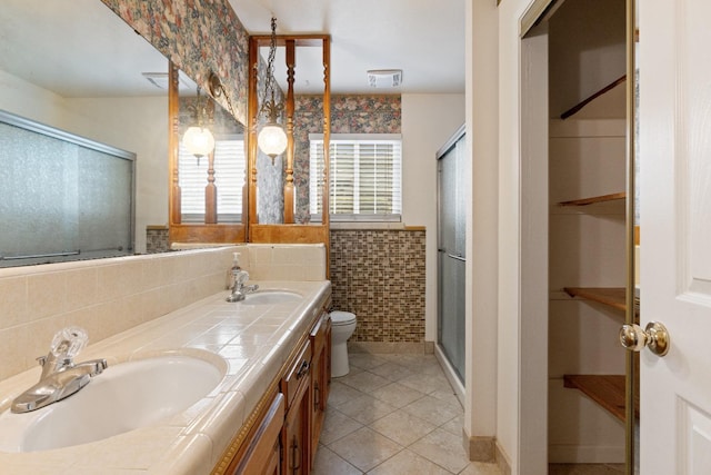 210 S Caesar Ave, Fresno, CA 93727 - full bath with a stall shower, toilet, double vanity, and tile patterned floors