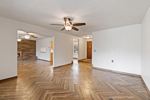 210 S Caesar Ave, Fresno, CA 93727 - empty room with a ceiling fan, baseboards, a brick fireplace, and a textured ceiling