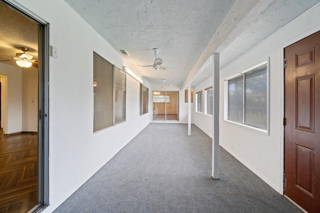 210 S Caesar Ave, Fresno, CA 93727 - hallway with a textured ceiling, healthy amount of natural light, carpet, and baseboards