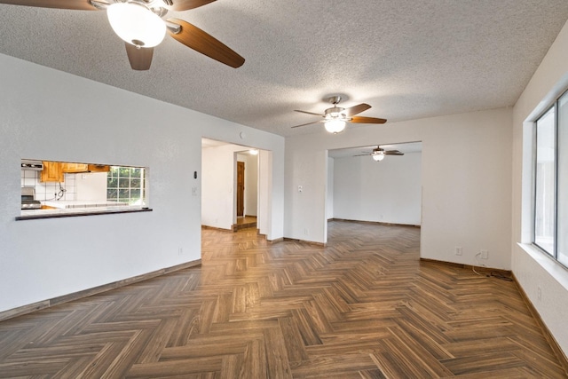 210 S Caesar Ave, Fresno, CA 93727 - spare room featuring ceiling fan, baseboards, and a textured ceiling