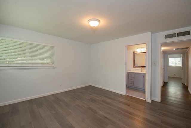 467 E San Bruno Ave, Fresno, CA 93710 - unfurnished bedroom with dark wood-style floors, baseboards, and ensuite bath