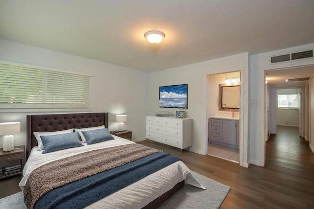 467 E San Bruno Ave, Fresno, CA 93710 - bedroom featuring wood finished floors, baseboards, and connected bathroom