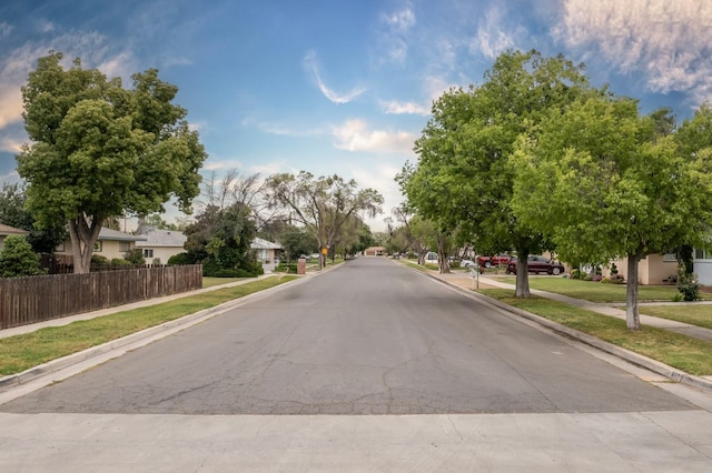 467 E San Bruno Ave, Fresno, CA 93710 - view of asphalt road featuring sidewalks, a residential view, and curbs