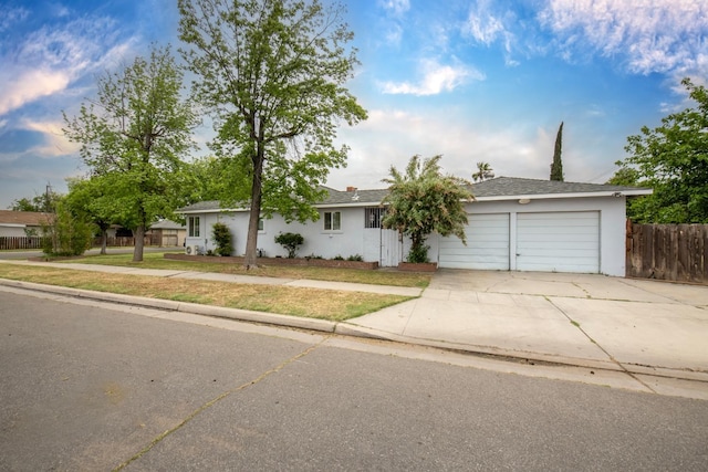 467 E San Bruno Ave, Fresno, CA 93710 - ranch-style home with a garage, driveway, and stucco siding