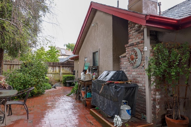 4240 W Sierra Ave, Fresno, CA 93722 - exterior space featuring fence, a patio, and stucco siding
