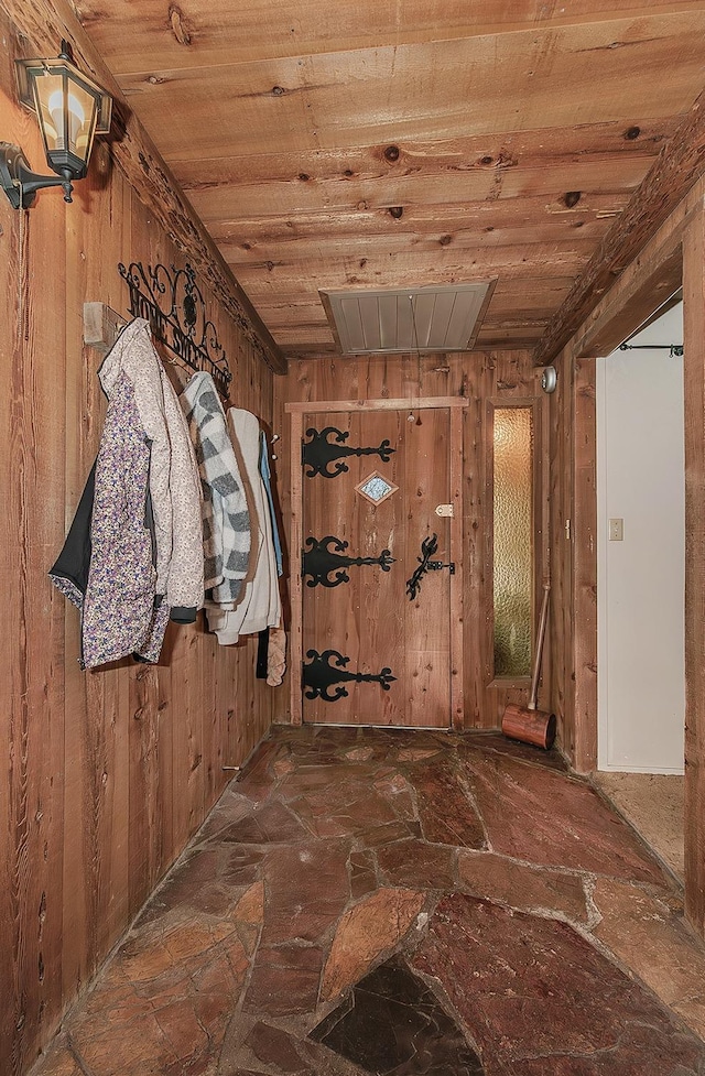 corridor featuring wood walls and wooden ceiling