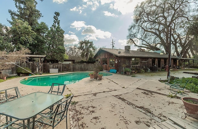 view of swimming pool with a fenced in pool, a patio, and fence