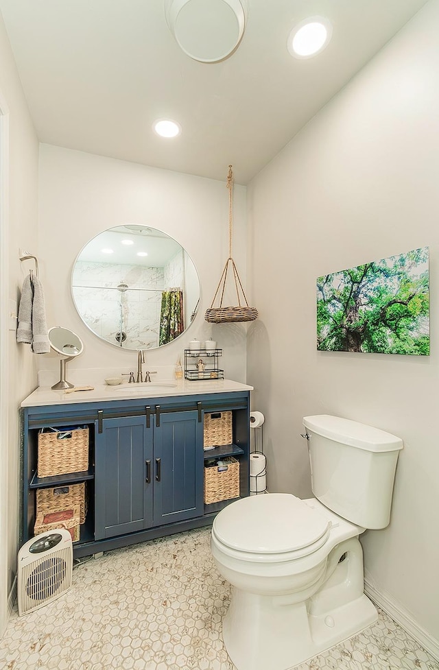 bathroom with toilet, recessed lighting, baseboards, walk in shower, and vanity