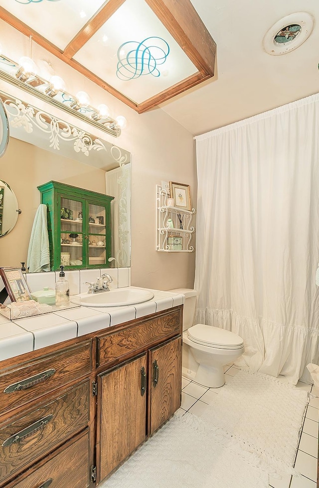 full bathroom featuring tile patterned floors, toilet, and vanity