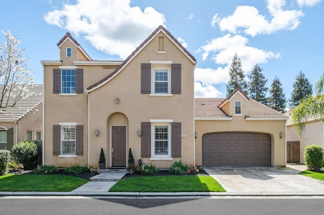 view of front of house with a tiled roof, a front lawn, stucco siding, driveway, and a garage