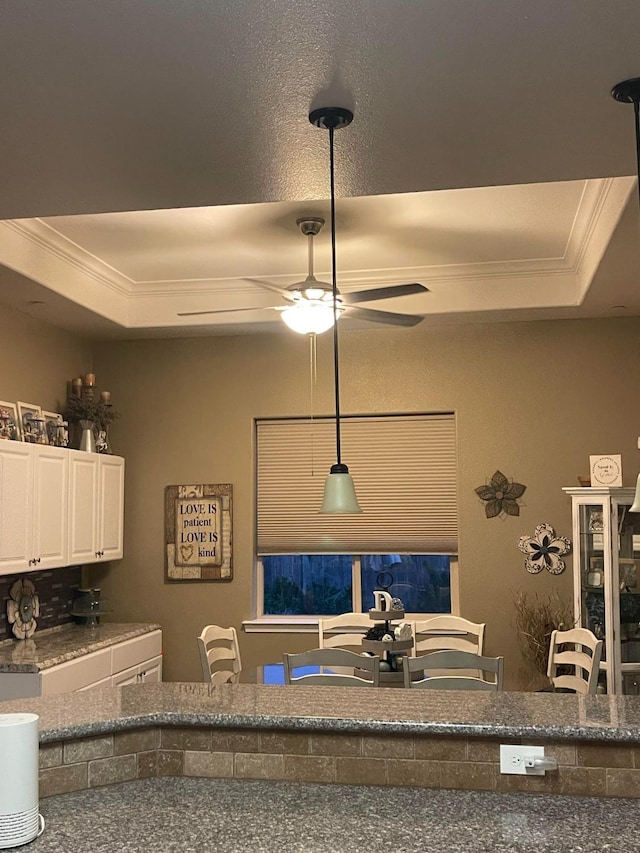 289 S Timberline Dr, Madera, CA 93637 - dining area view of ornamental molding, a ceiling fan, and a tray ceiling