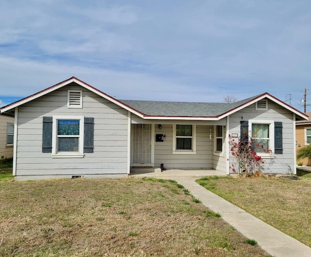 347 Coolidge St, Coalinga, CA 93210 - ranch-style house featuring roof with shingles, a porch, and a front yard