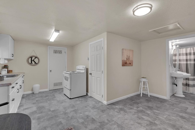1417 Humboldt Ave, Chowchilla, CA 93610 - laundry area with washer / dryer, attic access, a textured ceiling, and light flooring