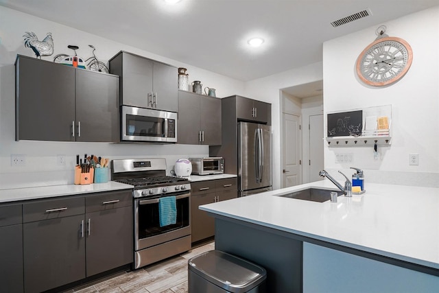 1935 Minarets Ln, Clovis, CA 93611 - kitchen featuring a sink, stainless steel appliances, visible vents, and light countertops