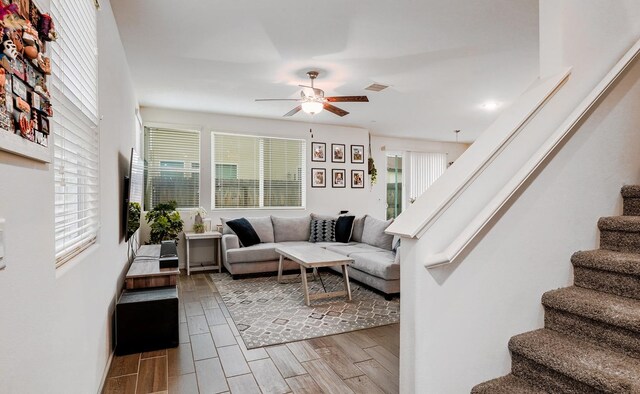 1935 Minarets Ln, Clovis, CA 93611 - living area with wood finish floors, visible vents, ceiling fan, and stairs
