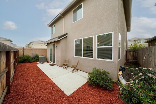 1935 Minarets Ln, Clovis, CA 93611 - rear view of house with a patio area, stucco siding, cooling unit, and a fenced backyard