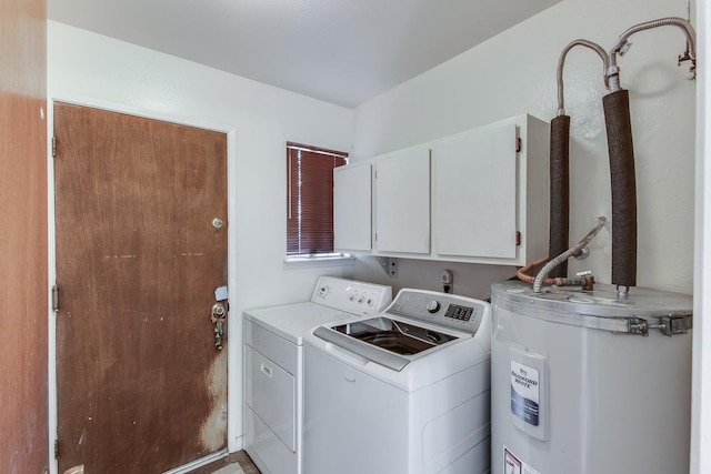 clothes washing area with cabinet space, water heater, and washing machine and clothes dryer