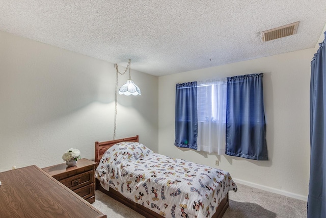bedroom with visible vents, carpet flooring, a textured ceiling, and baseboards