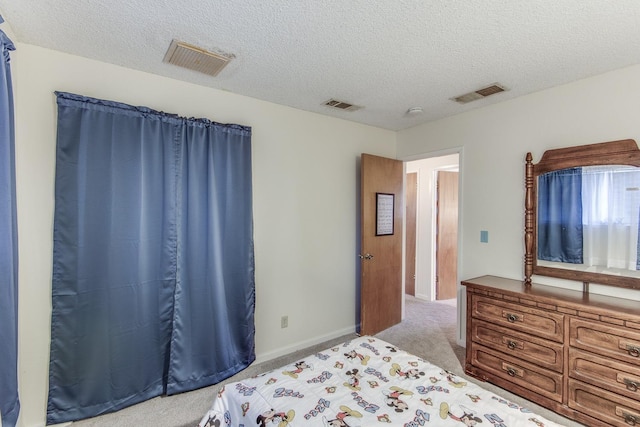 bedroom with light carpet, visible vents, and a textured ceiling