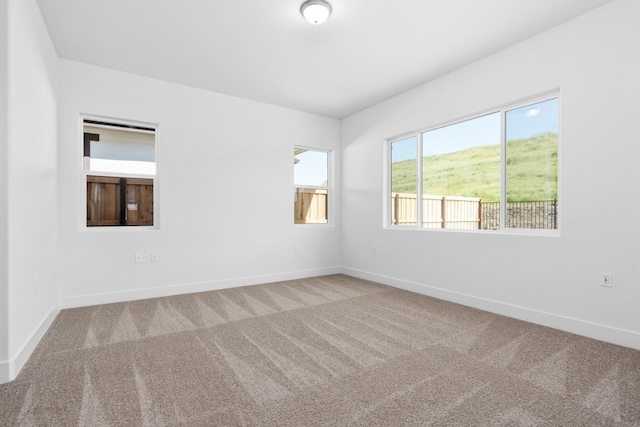 empty room with carpet floors and baseboards