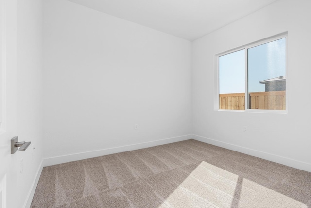 carpeted spare room with baseboards