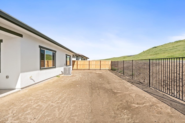 view of yard with a fenced backyard and cooling unit