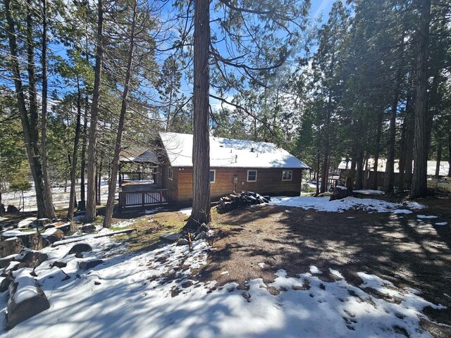 yard covered in snow with a deck